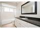 This bathroom features granite countertops, a large mirror, and a shower and tub combo at 1413 Timberbend Cir, Orlando, FL 32824