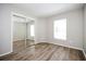 This bedroom features wood floors, a large window, and a mirrored sliding closet at 1413 Timberbend Cir, Orlando, FL 32824