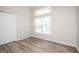 This bedroom features wood floors, a large window, and a closet at 1413 Timberbend Cir, Orlando, FL 32824