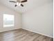 This bedroom features a ceiling fan, wood floors, and a window for plenty of natural light at 1413 Timberbend Cir, Orlando, FL 32824