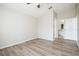 This bedroom features a ceiling fan, wood floors, and a doorway leading to the bathroom at 1413 Timberbend Cir, Orlando, FL 32824