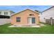 The rear exterior shows an inviting sliding door and well-kept lawn at 1413 Timberbend Cir, Orlando, FL 32824