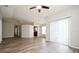 Open-concept living room with hardwood floors leading into dining and kitchen areas at 1413 Timberbend Cir, Orlando, FL 32824