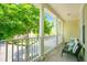 Relaxing tiled balcony with seating and a view of tree-lined street at 1425 Chatfield Pl, Orlando, FL 32814