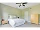 Bright bedroom with ceiling fan, and light-colored walls, carpet, and bedding at 1425 Chatfield Pl, Orlando, FL 32814