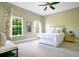 This comfortable bedroom features neutral carpet, two windows, and a ceiling fan at 1425 Chatfield Pl, Orlando, FL 32814