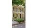 Beautiful yellow townhome featuring a private balcony, an inviting front porch, and well-maintained landscaping at 1425 Chatfield Pl, Orlando, FL 32814
