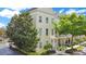 Three-story traditional home with white trim, green trees, and well-kept landscaping at 1425 Chatfield Pl, Orlando, FL 32814