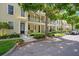 Charming townhome exterior featuring well-manicured landscaping, a front porch, and a private balcony at 1425 Chatfield Pl, Orlando, FL 32814