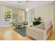 Comfortable living room features hardwood floors, two large windows, and a comfortable sitting area at 1425 Chatfield Pl, Orlando, FL 32814