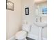 Powder room featuring a white sink and toilet at 1425 Chatfield Pl, Orlando, FL 32814