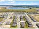 Expansive aerial view of a new residential community with a scenic lake and surrounding greenery at 14613 Erice Ave, Clermont, FL 34714
