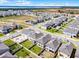 An aerial view of the home highlighting the neighborhood and the lake nearby at 14613 Erice Ave, Clermont, FL 34714
