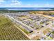 An aerial showcases a new community near a lake with modern homes and community planning at 14613 Erice Ave, Clermont, FL 34714