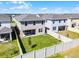 Aerial view of the fenced backyard, patio, and the back of the home at 14613 Erice Ave, Clermont, FL 34714