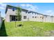 Backyard features grass, a fence, and the rear of the home at 14613 Erice Ave, Clermont, FL 34714