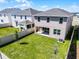 A well-maintained backyard featuring a pristine lawn and contemporary fencing at 14613 Erice Ave, Clermont, FL 34714