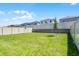 Fenced backyard features a lush lawn and well-maintained landscaping at 14613 Erice Ave, Clermont, FL 34714