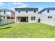 Fenced backyard with green grass and exterior of the home at 14613 Erice Ave, Clermont, FL 34714