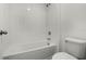 This bathroom features a tub and shower combination with white tiling at 14613 Erice Ave, Clermont, FL 34714