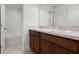 Bathroom features a double vanity with granite countertops and wood cabinets at 14613 Erice Ave, Clermont, FL 34714