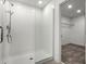 Modern bathroom featuring glass-enclosed shower with chrome fixtures and white subway tiles at 14613 Erice Ave, Clermont, FL 34714