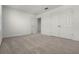 Neutral bedroom features a carpeted floor, a closet, and natural light at 14613 Erice Ave, Clermont, FL 34714
