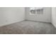 Bedroom featuring neutral colored carpet and window at 14613 Erice Ave, Clermont, FL 34714