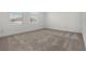 Spacious bedroom with neutral carpet and windows providing natural light at 14613 Erice Ave, Clermont, FL 34714