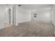 Spacious bedroom with neutral carpet, white walls, and natural light from a window at 14613 Erice Ave, Clermont, FL 34714