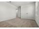 Bedroom with neutral carpet, double door closet, and entryway to additional room at 14613 Erice Ave, Clermont, FL 34714