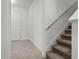 Bright entryway with a staircase featuring carpeted steps and a white railing at 14613 Erice Ave, Clermont, FL 34714