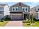 Attractive two-story home featuring a brick driveway, tidy lawn and an attached garage at 14613 Erice Ave, Clermont, FL 34714
