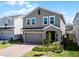 Charming two-story home with a brick driveway, attached garage, and well-maintained landscaping at 14613 Erice Ave, Clermont, FL 34714