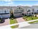 Charming two-story home featuring a brick driveway, manicured lawn, and inviting curb appeal at 14613 Erice Ave, Clermont, FL 34714