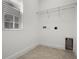 Laundry room with tile floors, a window, and washer/dryer hookups at 14613 Erice Ave, Clermont, FL 34714