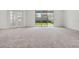 Spacious living room with sliding glass doors providing ample natural light and backyard views at 14613 Erice Ave, Clermont, FL 34714