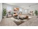 Staged main bedroom featuring neutral carpet, windows and decor at 14613 Erice Ave, Clermont, FL 34714
