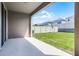 Covered patio overlooks the fenced backyard with green grass at 14613 Erice Ave, Clermont, FL 34714
