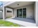 The back patio features concrete floors, with a grassy yard beyond at 14613 Erice Ave, Clermont, FL 34714