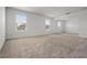 Neutral carpeted room with multiple windows allowing natural light at 14613 Erice Ave, Clermont, FL 34714