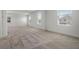 Neutral carpeted room with multiple windows allowing natural light at 14613 Erice Ave, Clermont, FL 34714