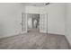 Room featuring white framed glass doors and neutral carpeting at 14613 Erice Ave, Clermont, FL 34714