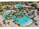 Breathtaking aerial view of a resort community featuring pools, lush landscaping, and various amenities at 1518 Rolling Fairway Dr, Davenport, FL 33896