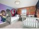 Whimsical bedroom features a fun Star Wars mural and two twin beds with large windows at 1518 Rolling Fairway Dr, Davenport, FL 33896