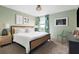 Bright bedroom showcasing a rattan bed frame, patterned curtains, and stylish side table at 1518 Rolling Fairway Dr, Davenport, FL 33896