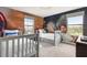 Whimsical bedroom features a fun Star Wars mural and two twin beds with large windows at 1518 Rolling Fairway Dr, Davenport, FL 33896