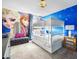 Cheerful ' bedroom features a Frozen themed mural and bunk beds with pull-out drawers at 1518 Rolling Fairway Dr, Davenport, FL 33896