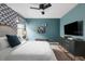Contemporary bedroom featuring a sleek television, stylish dresser, and minimalist design at 1518 Rolling Fairway Dr, Davenport, FL 33896
