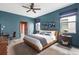 Stylish bedroom showcases a modern design with sleek furniture, a ceiling fan, and ample natural light at 1518 Rolling Fairway Dr, Davenport, FL 33896